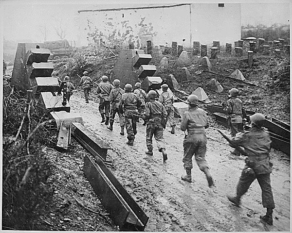 Soldiers of the 90th Infantry Division, an Army Reserve unit from Texas and Oklahoma, advance into Germany during World War II.