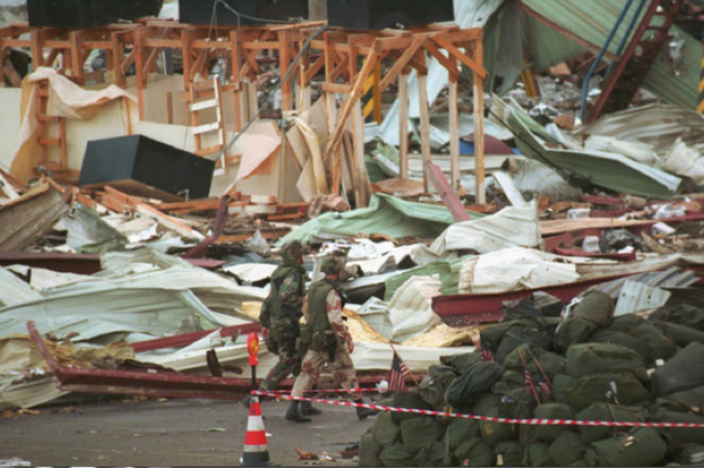 Two U.S. Soldiers walk past a pile of duffel bags decorated with small American flags following a SCUD missile attack on the U.S. military barracks at Dhahran, Saudi Arabia, Feb. 25, 1991. Two U.S. Soldiers walk past a pile of duffel bags decorated with small American flags following a SCUD missile attack on the U.S. military barracks at Dhahran, Saudi Arabia, Feb. 25, 1991.
